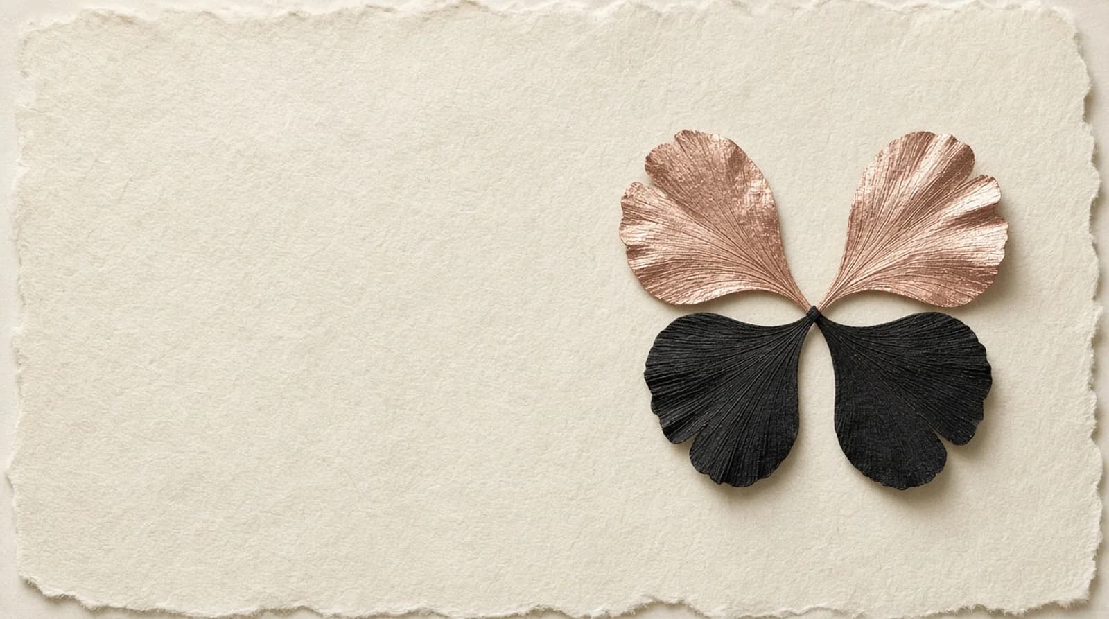 Four ginkgo leaves in a butterfly shape, rose-gold upper wings and black lower wings, on cream deckle-edge paper.